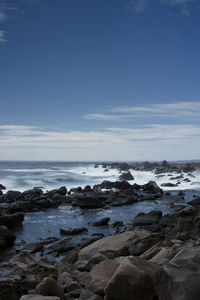 Rocks on beach against sky