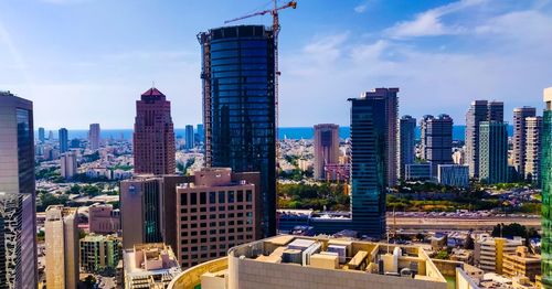 Modern buildings in city against sky