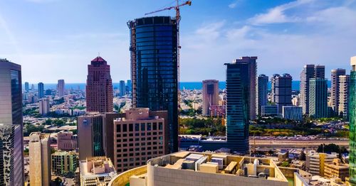 Modern buildings in city against sky