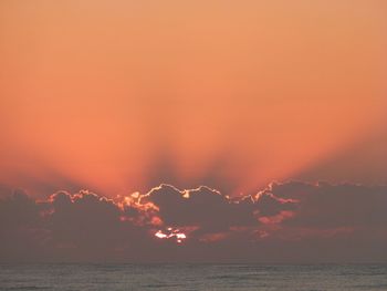 Scenic view of sea against orange sky