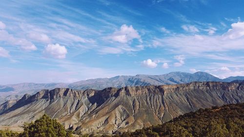 Scenic view of mountains against cloudy sky