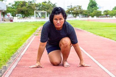 Portrait of mature woman on sports track