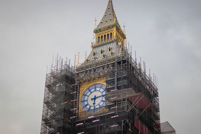 Low angle view of clock tower against building