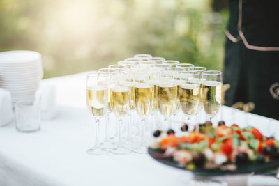 Glasses of champagne and snacks on the table at the event, catering