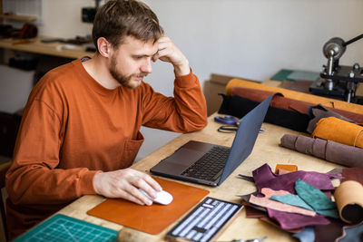 Man working on table at home
