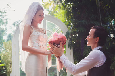 Groom giving flowers to bride at wedding