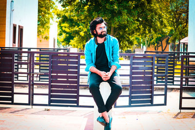 Portrait of young man sitting on seat