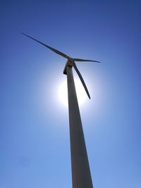 Low angle view of traditional windmill against clear blue sky