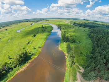 Aerial view of mologa river on green landscape against sky