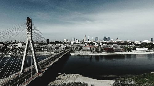 Bridge over river with city in background