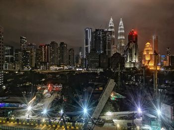 High angle view of illuminated city buildings at night