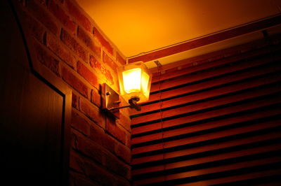 Low angle view of illuminated lamp in building