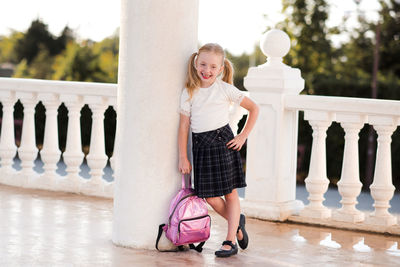 Pupil kid girl 4-5 year old posing outdoors. looking at camera. back to school.