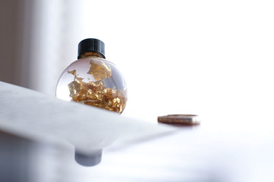 Close-up of glass bottle on table