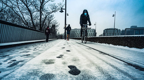 Man walking on snow covered trees