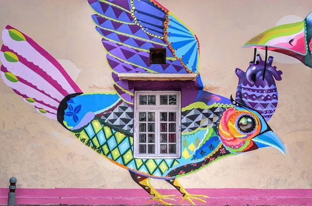 art, art and craft, creativity, multi colored, built structure, architecture, human representation, animal representation, graffiti, low angle view, wall - building feature, building exterior, blue, colorful, craft, sculpture, mural, design