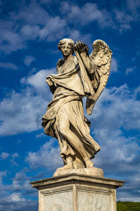 Low angle view of statue against cloudy sky