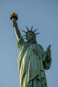 Low angle view of statue of liberty against sky