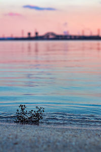 Scenic view of lake against sky at sunset