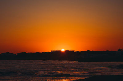 Scenic view of sea against romantic sky at sunset