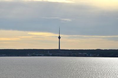 Silhouette of building against cloudy sky