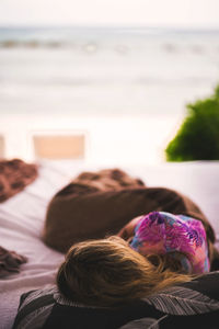 High angle view of woman lying on bed at home