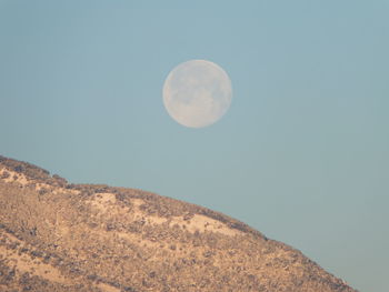 Low angle view of moon against clear sky at night