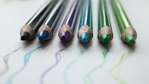 Close-up of multi colored pencils on table