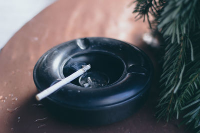 Close up of burning cigarette in ashtray