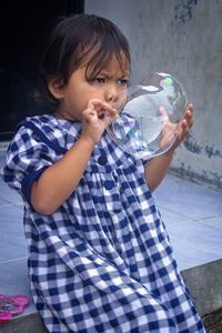 Side view of boy blowing bubbles