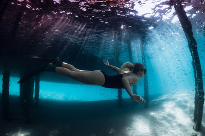 Low section of woman swimming in pool