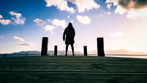 Silhouette woman standing against sky