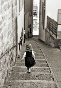 Rear view of girl moving on steps