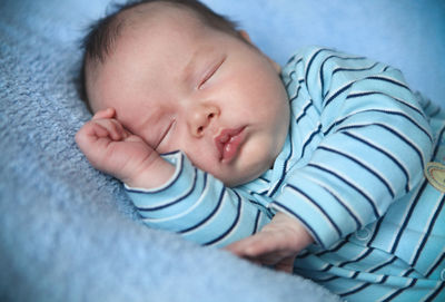 High angle view of baby sleeping on bed