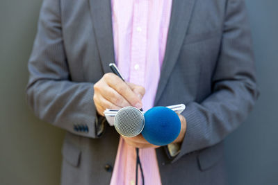 Midsection of man holding umbrella