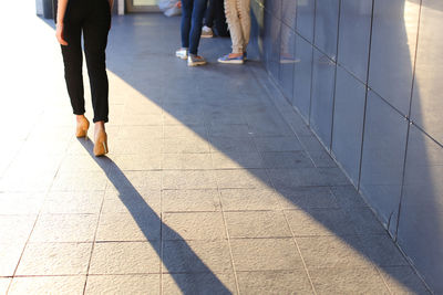 Low section of people walking on street