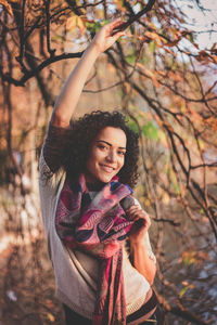Portrait of smiling young woman in forest