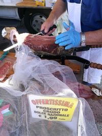 Midsection of man for sale at market