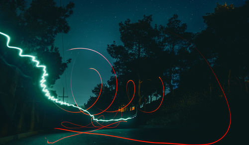 Low angle view of light trails at night