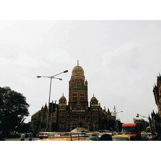 building exterior, architecture, built structure, transfer print, city, sky, auto post production filter, building, tower, low angle view, day, residential building, outdoors, tree, transportation, city life, residential structure, tall - high, incidental people, clear sky