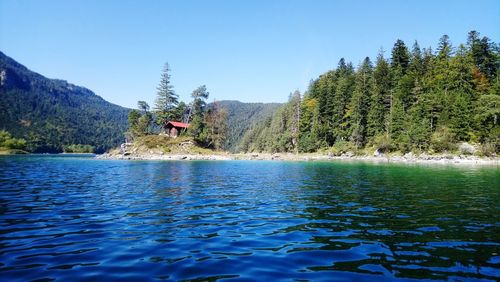 Scenic view of lake against clear blue sky