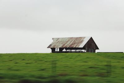 Built structure on field against sky