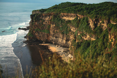 Rock formations by sea against sky