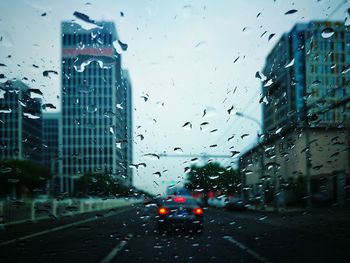 View of city street against cloudy sky