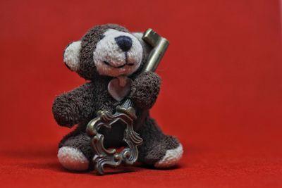 Close-up of stuffed toy against red background