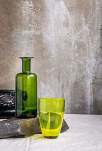 Close-up of drink in glass on table against wall