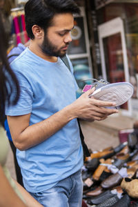 Man choosing shoes in market