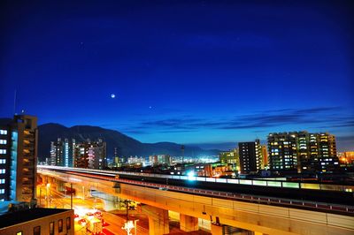 High angle view of illuminated city buildings at night