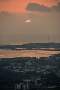 High angle view of buildings against sky at sunset