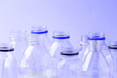 Close-up of empty bottles against blue background